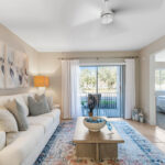 Two-BR Apartments in Palm Bay, FL - Meri Palm Bay - Staged Living Room with Sliding Glass Door with Patio Access