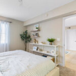 One-BR Apartments in Palm Bay, FL - Meri Palm Bay - Staged Bedroom with Plush Carpet Flooring, Cream Neutral Walls, and a Window